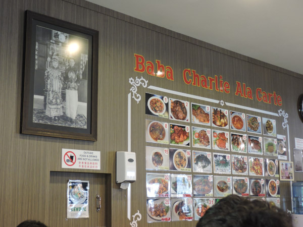 traditional baba nyonya photo and traditional nyonya dishes menu on the wall in Melaka Malaysia